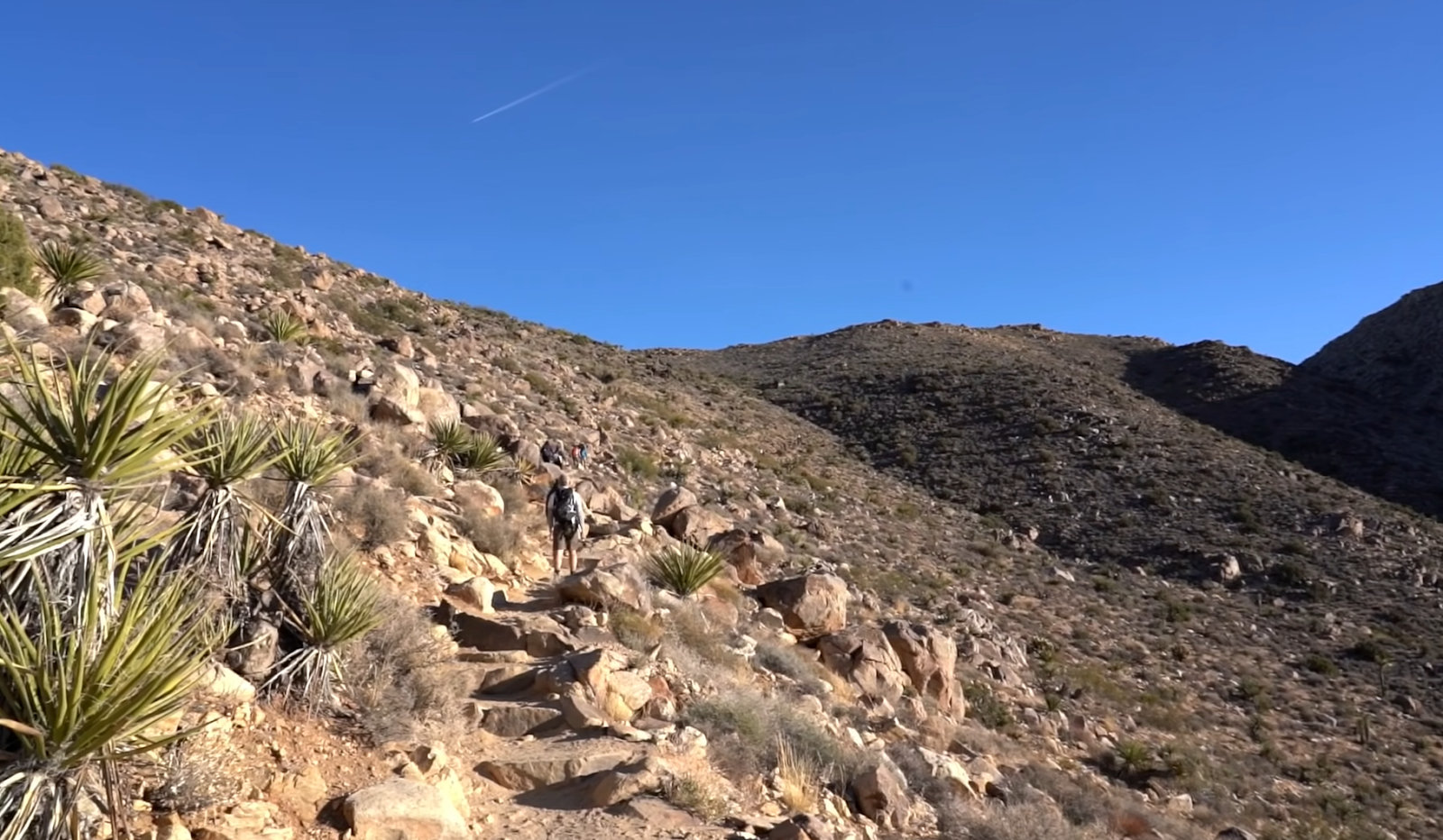 ray mountain - hills covered with rocks and cacti plants, people on the mountain