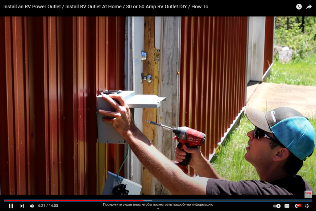 A man installs an outlet with a tool