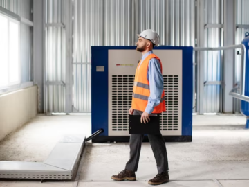 A man standing near a generator