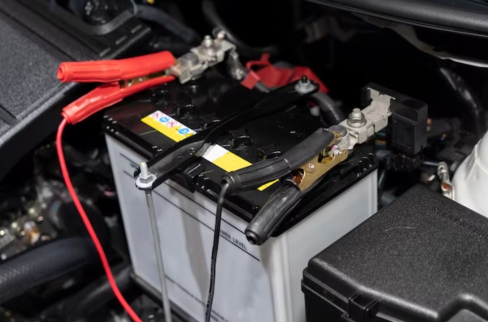 jumper cables attached to a car battery